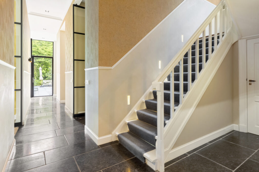 Modern hallway with staircase and outdoor view