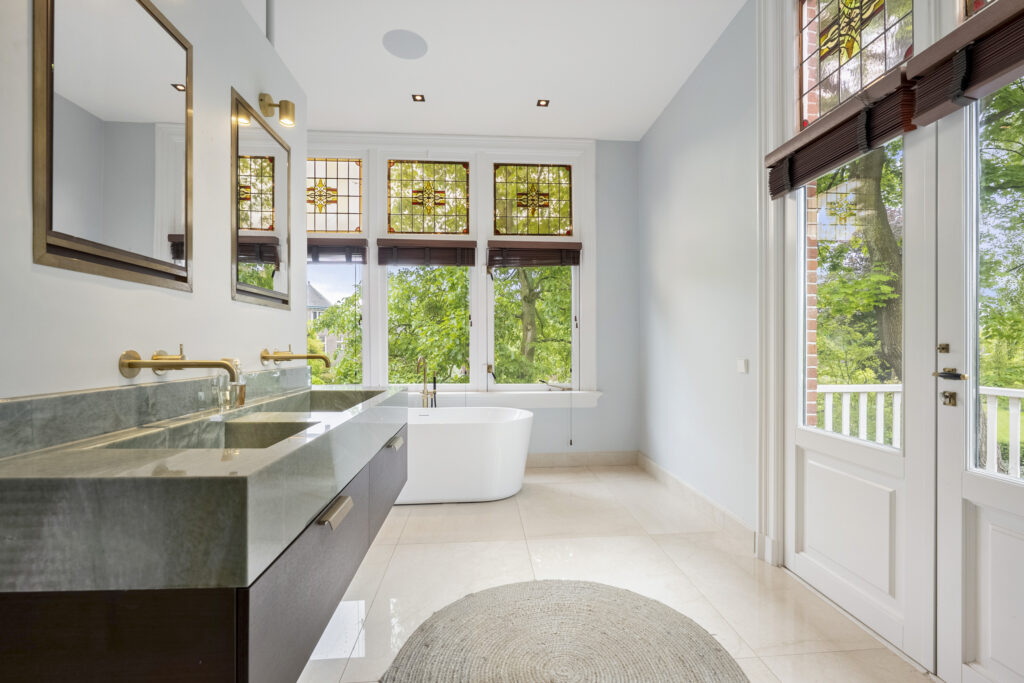 Spacious bathroom with double sinks and freestanding tub.