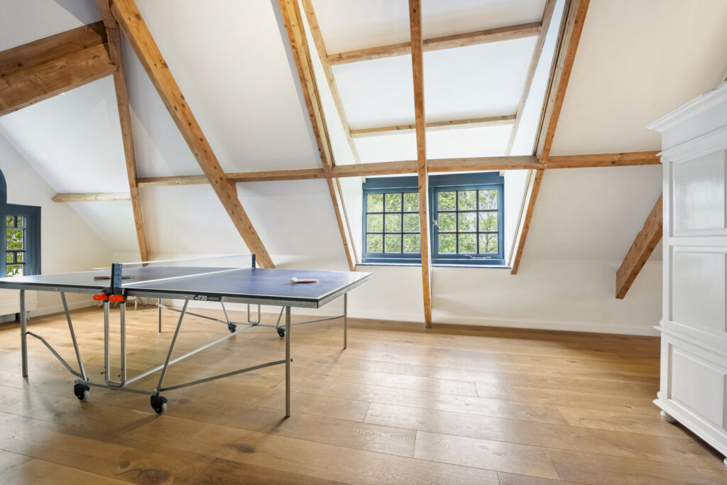 Attic room with table tennis setup.
