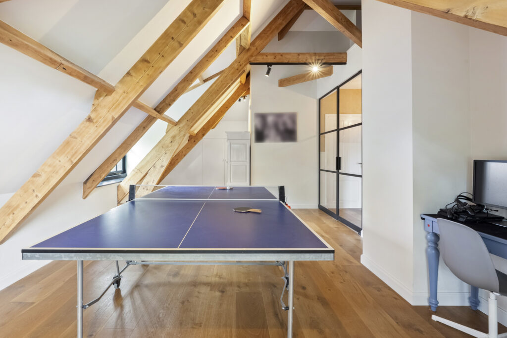 Attic room with ping pong table and desk
