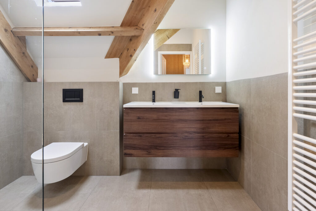 Modern bathroom with wood accents and floating vanity.