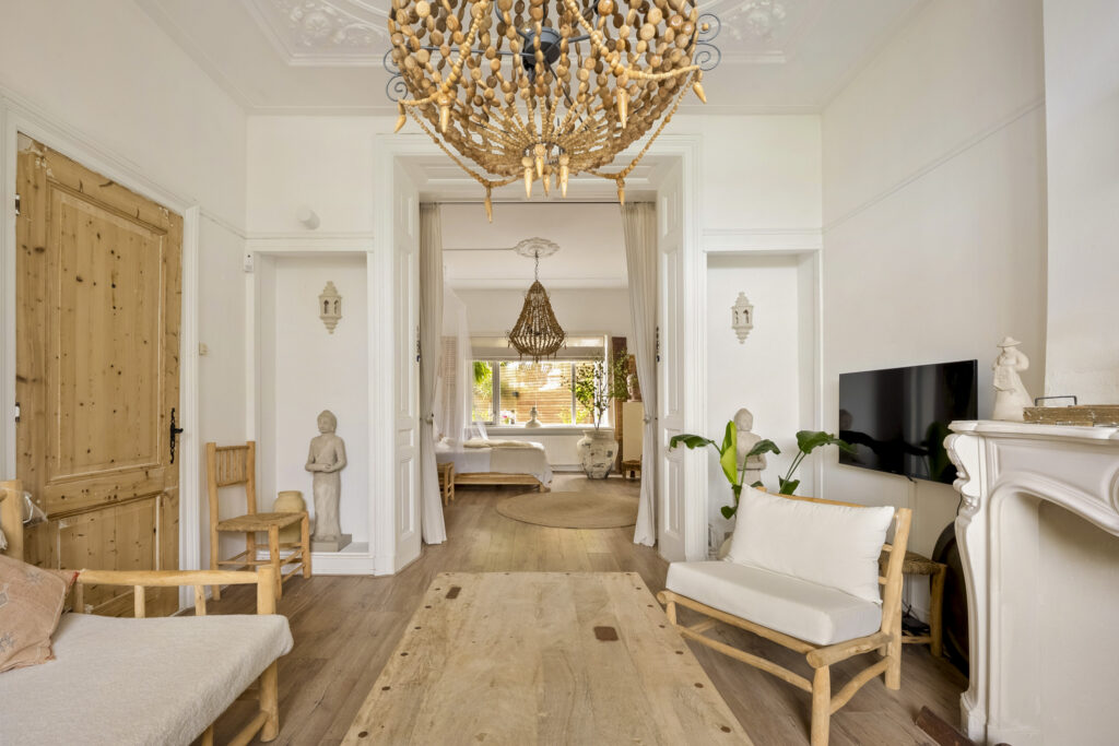 Elegant living room with chandelier and natural decor.
