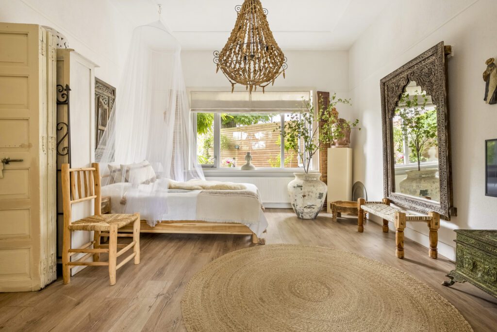Rustic bedroom with canopy bed and decorative elements.