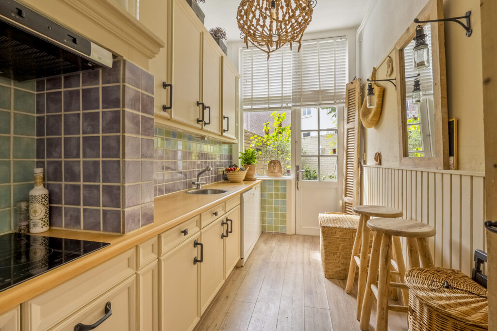 Rustic kitchen with wooden counter and stools.