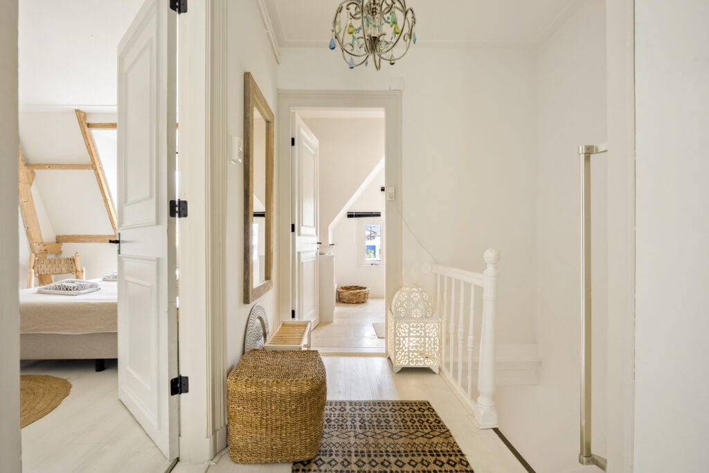 Minimalist hallway with natural decor and chandelier