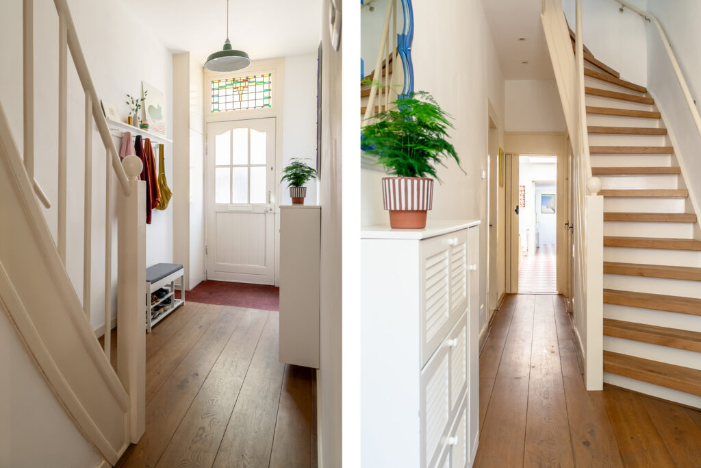Bright hallway with staircase and wooden floors.