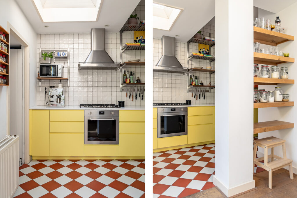 Modern kitchen with yellow cabinets, checkered floor.