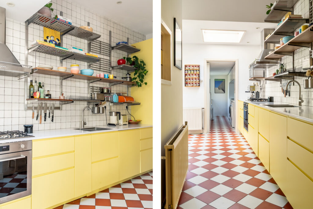 Bright kitchen with yellow cabinets and checkered floors.