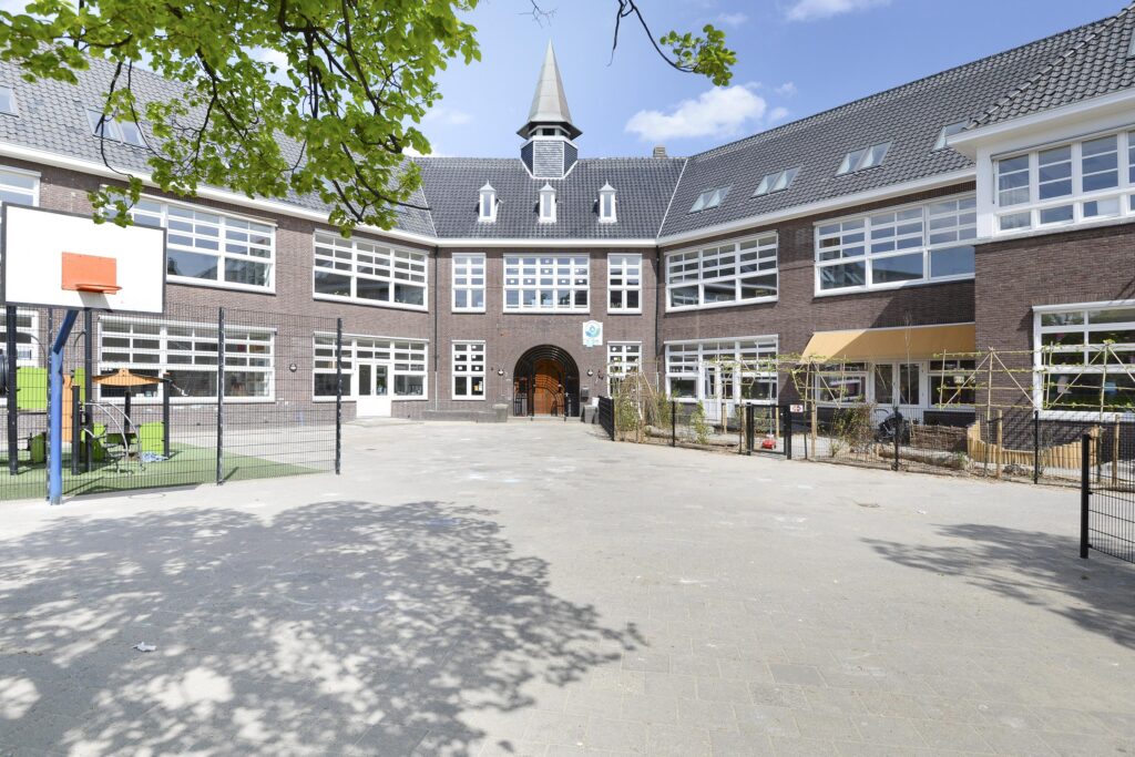 Brick school building with a large courtyard.