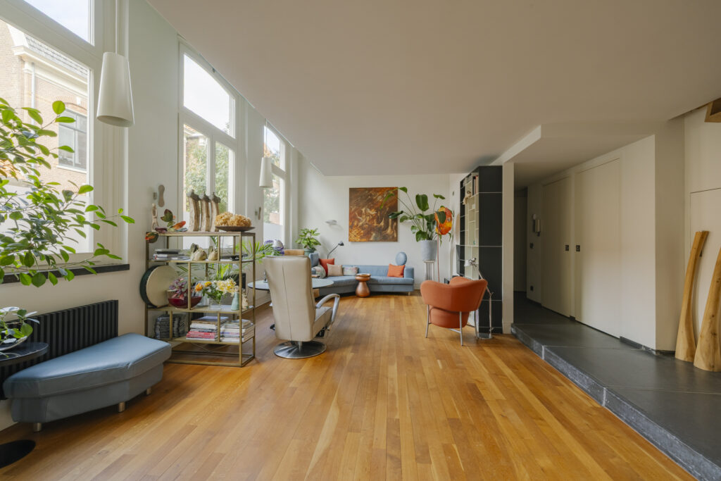 Spacious modern living room with plants and art.