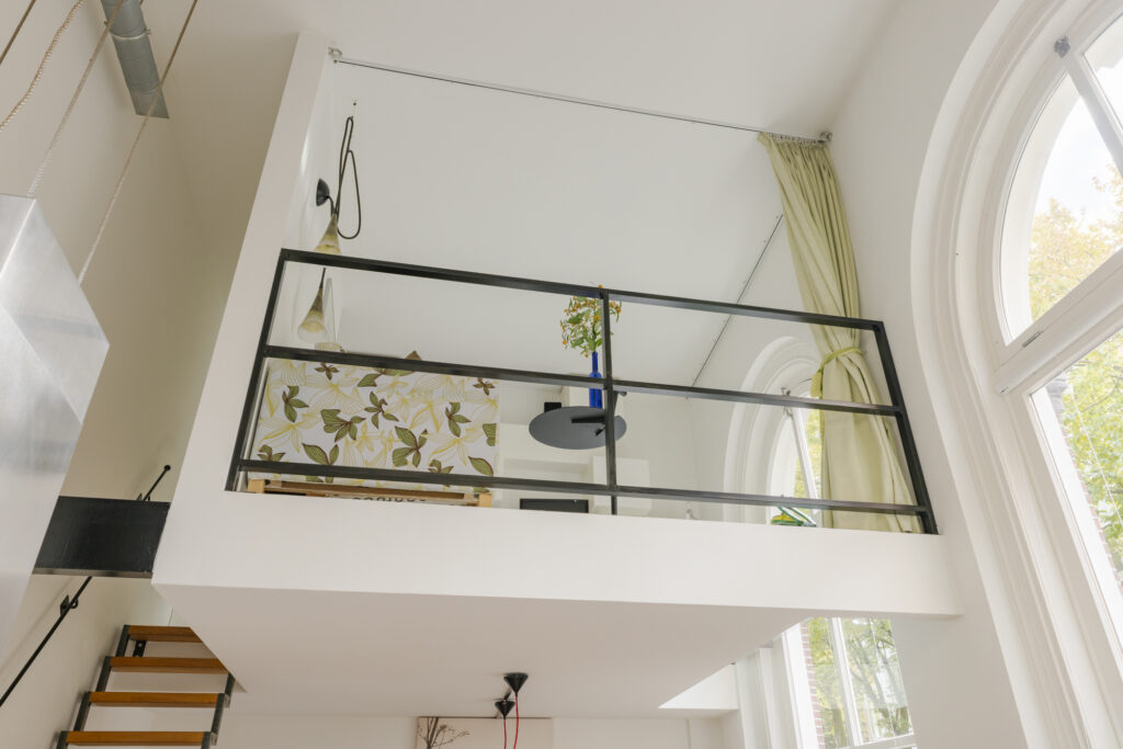 Modern loft with staircase and large windows