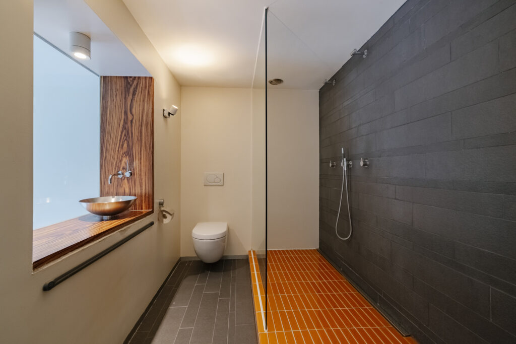 Modern bathroom with shower and wooden accents