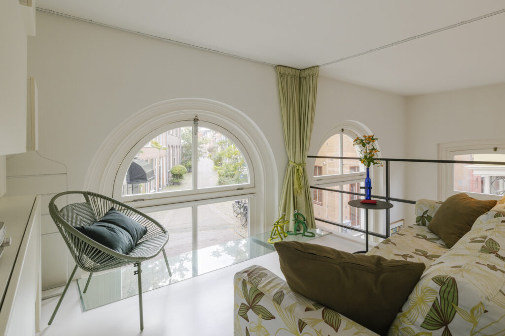 Cozy loft with large windows and street view.