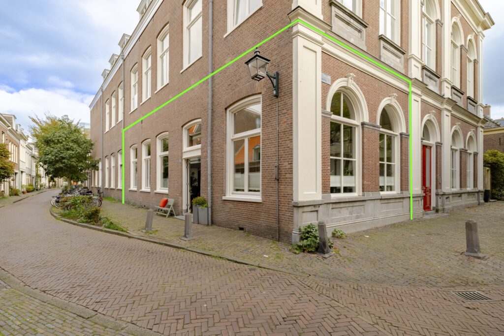 Corner of brick building on cobblestone street