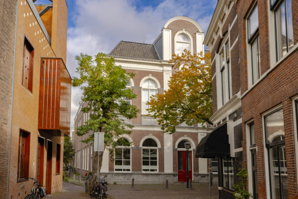 Brick building with trees in urban street view.
