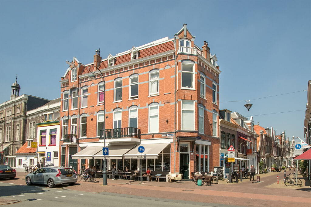 Historic Dutch street with bicycles and cafes.