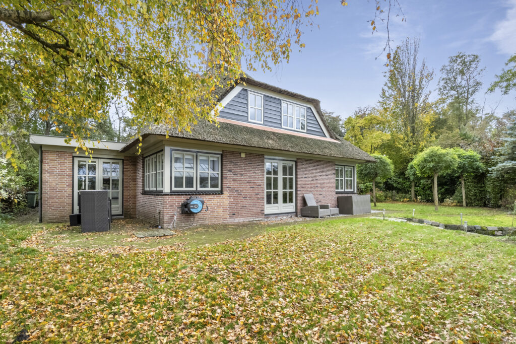 Charming house with garden in fall landscape.