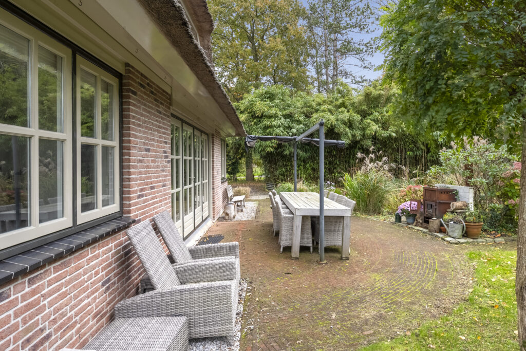 Brick house patio with table and chairs
