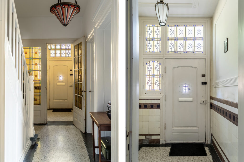 Art Deco foyer with stained glass windows and tiles.