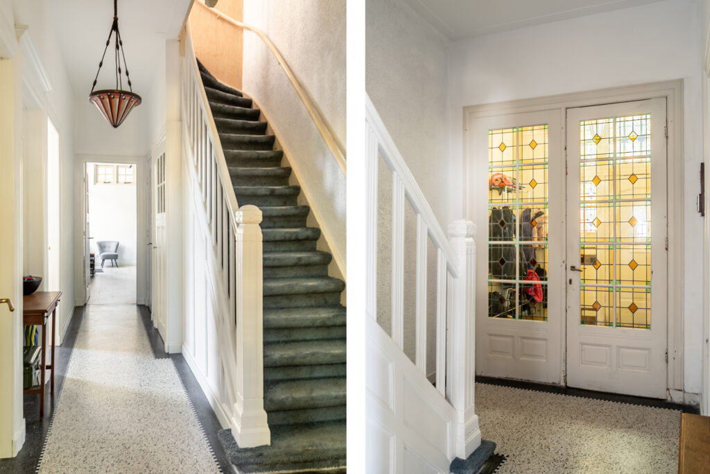Elegant hallway with stained glass doors and staircase
