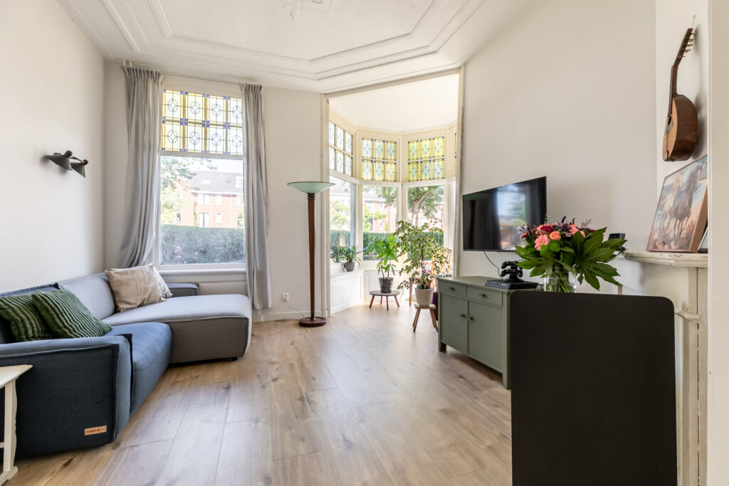 Bright living room with modern decor and plants.