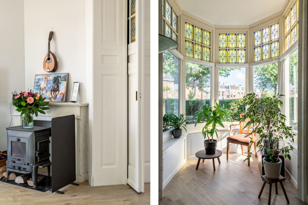 Cozy room with plants and stained glass windows.
