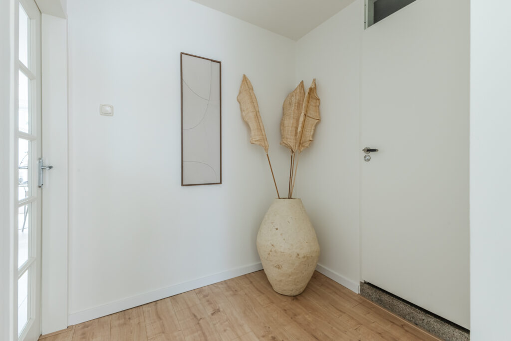 Minimalist corner with vase and abstract artwork