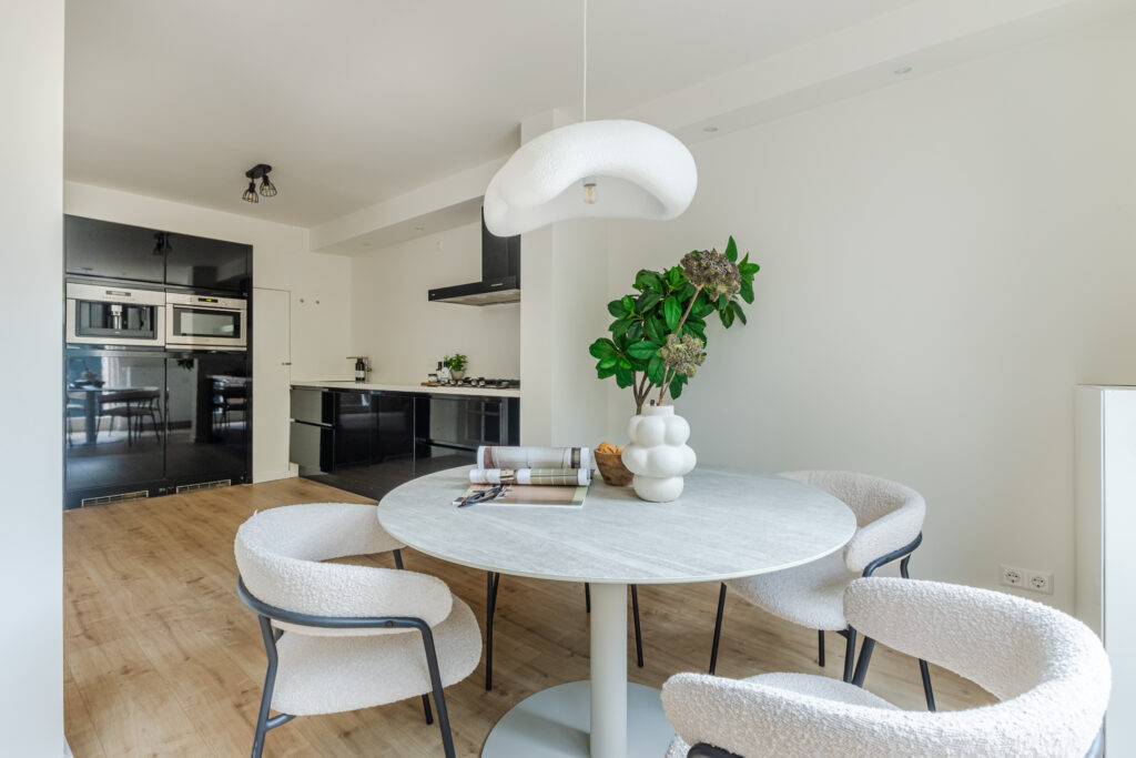 Modern kitchen with round dining table and plant