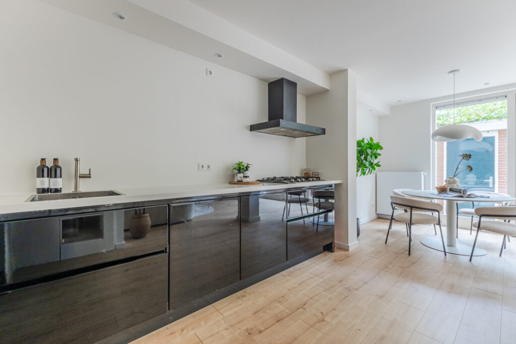 Modern kitchen interior with dining area and plants.