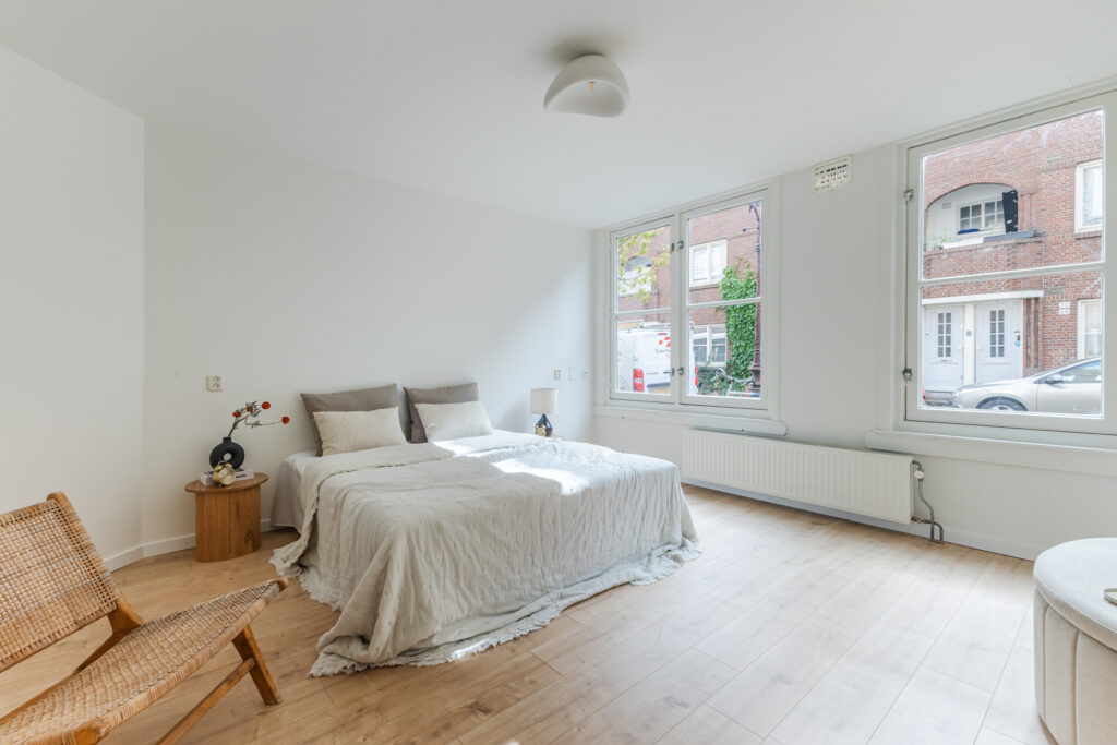 Bright, minimalist bedroom with cozy double bed.