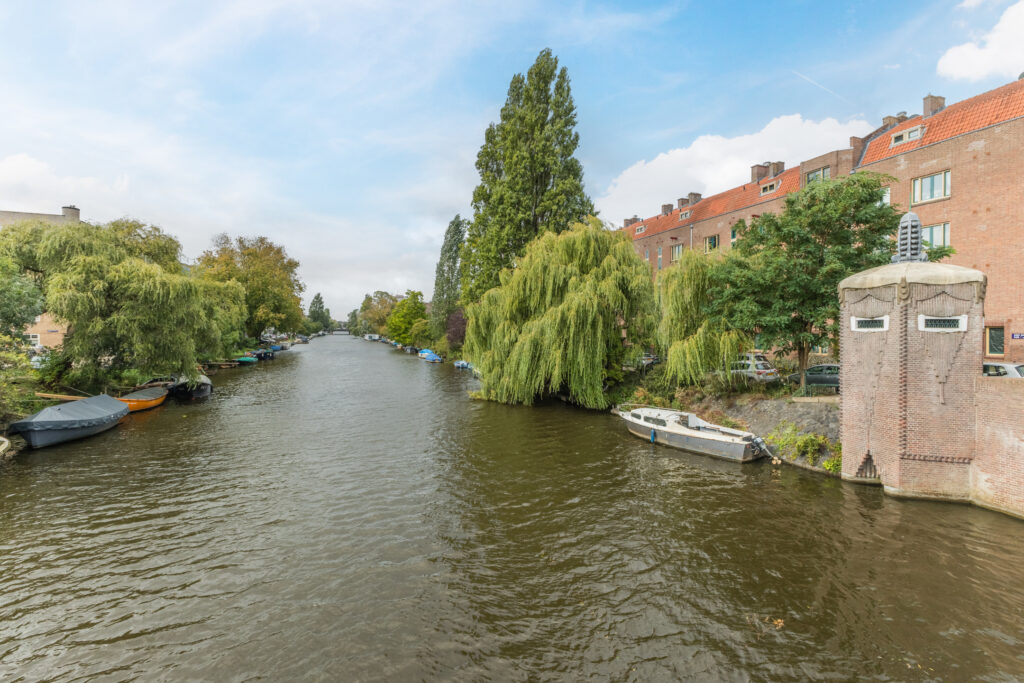 Canal with boats and trees, Amsterdam scene