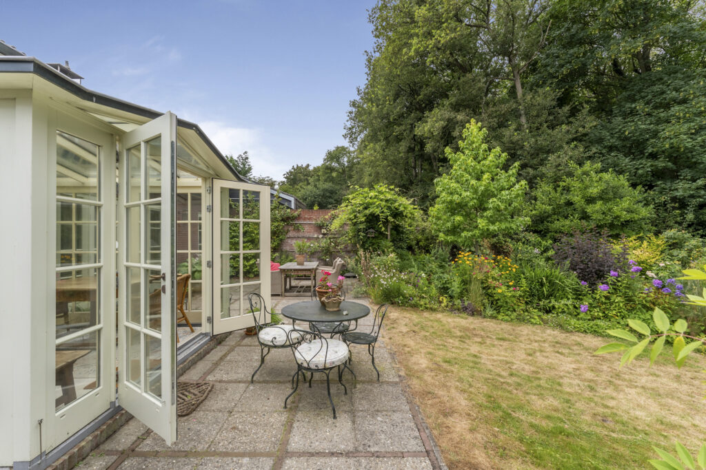 Cozy garden with patio and open French doors