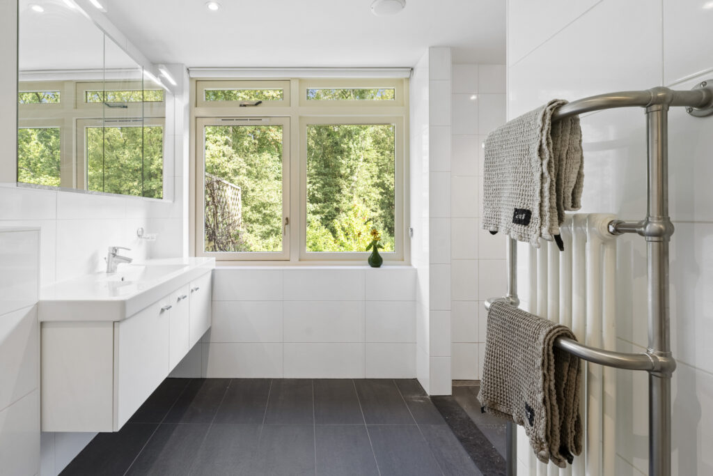 Modern bright bathroom with large window view