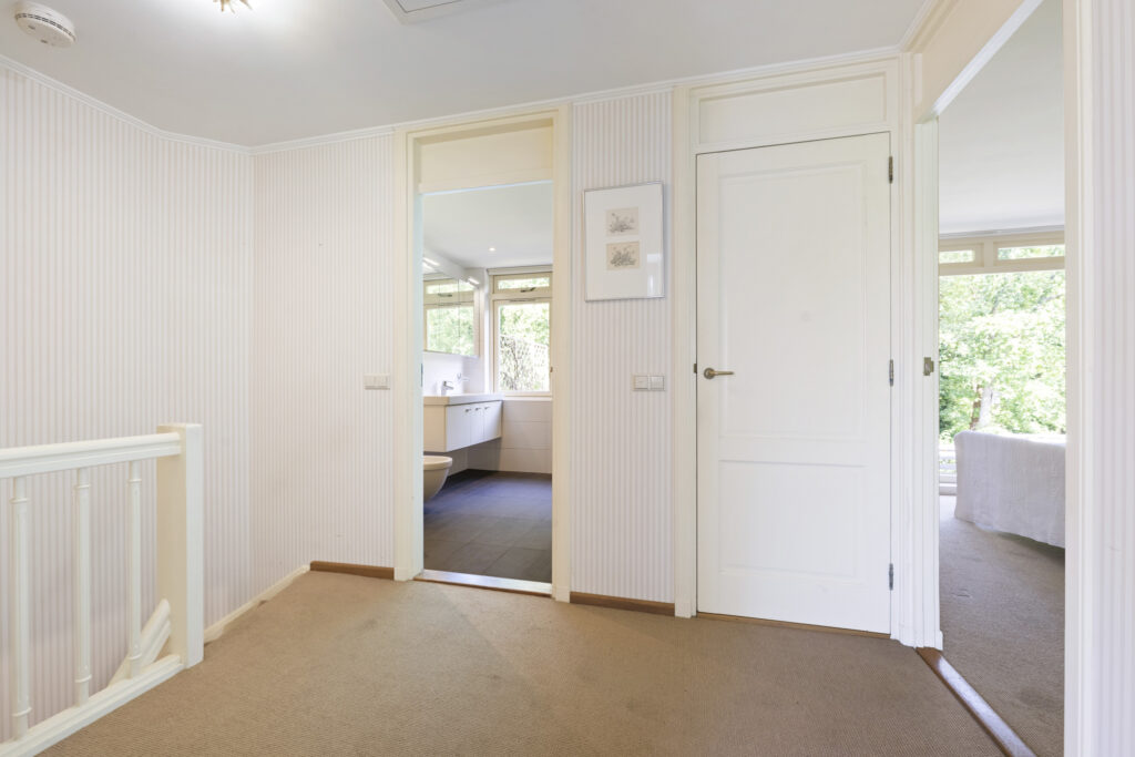 Hallway with open doors and natural light.