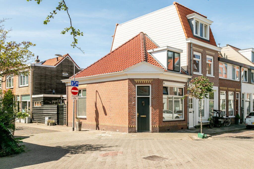 Corner brick house with red tiled roof.