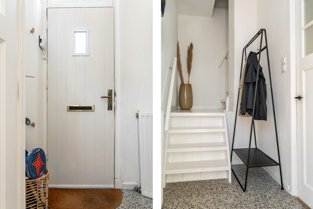 White entryway with staircase and coat rack