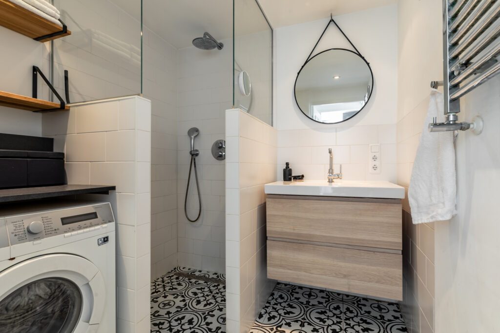 Modern bathroom with shower and washing machine.