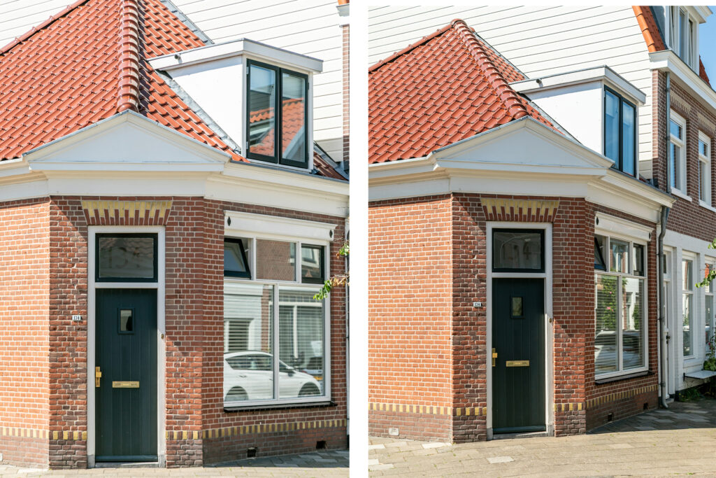 Brick house corner with red roof and green door.