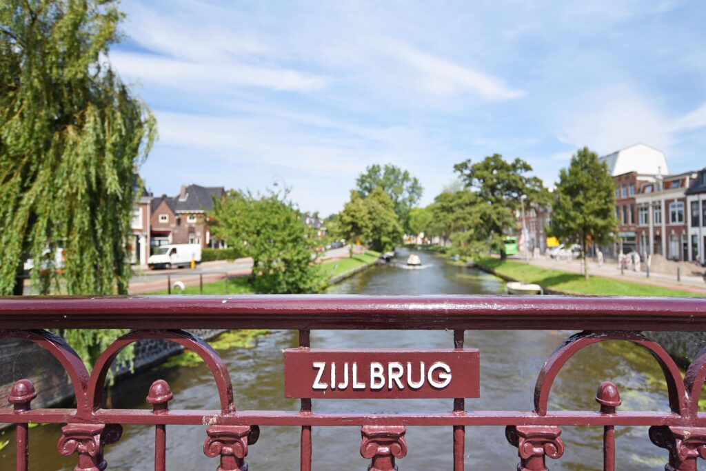 Zijlbrug bridge over canal with trees and buildings.