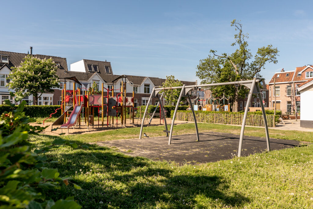 Empty playground with climbing frames and swings.