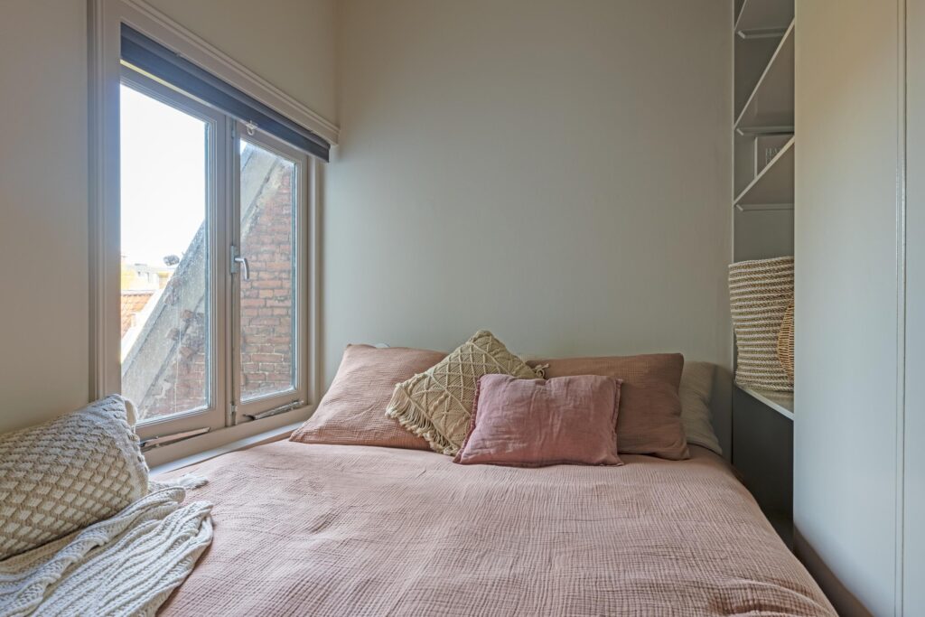 Cozy bedroom with pillows and window view