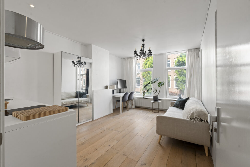 Cozy living room with wooden floor and large windows