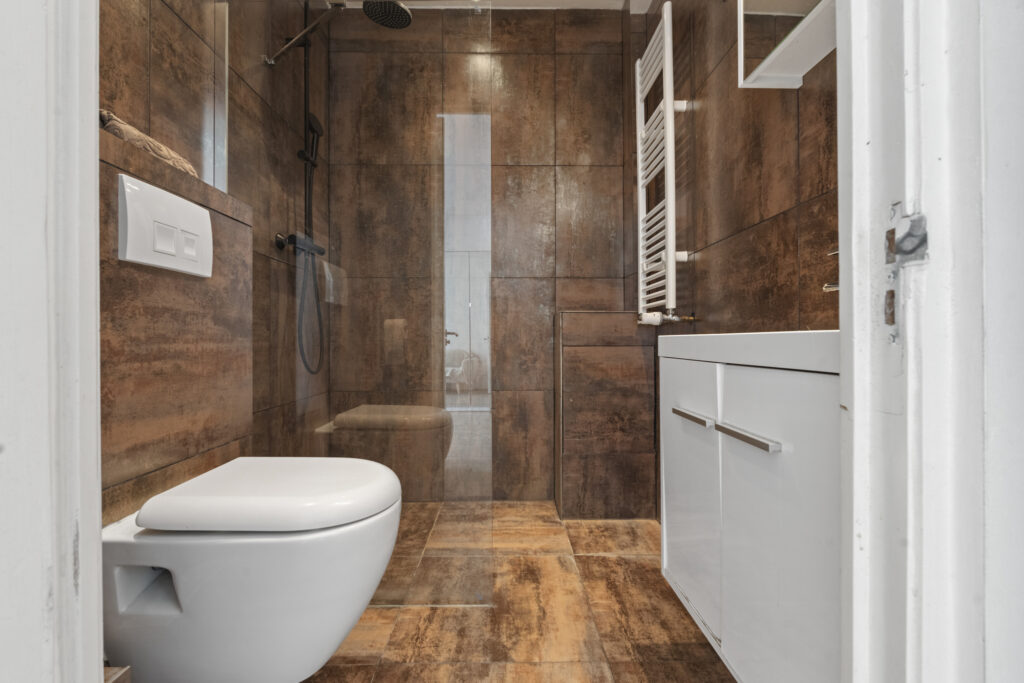 Modern bathroom with shower, toilet, and sink.
