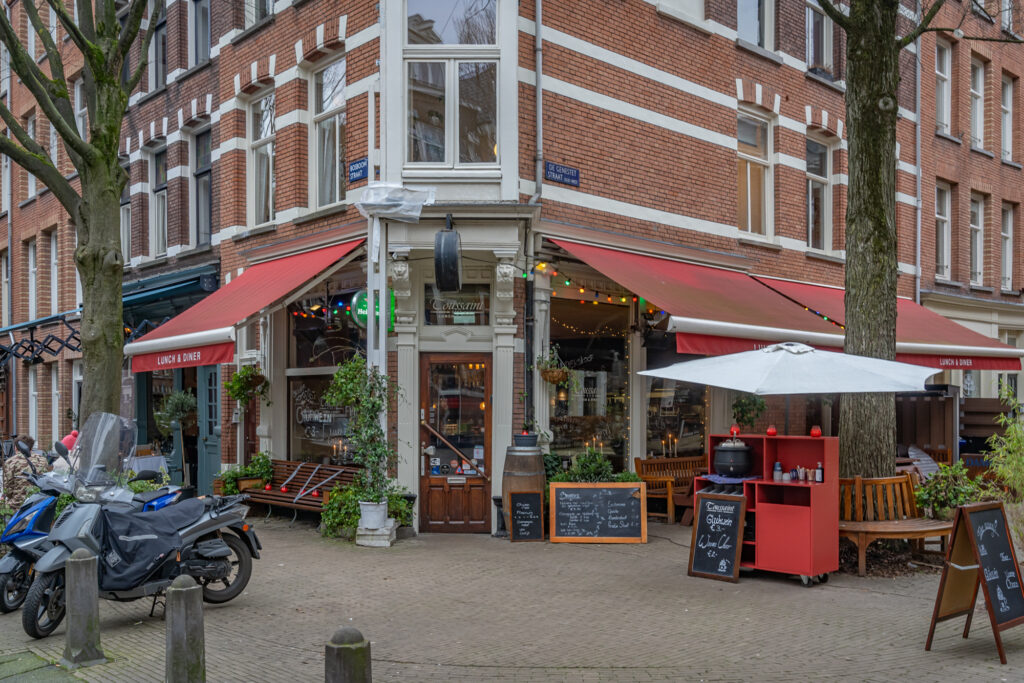 Cozy street corner cafe with outdoor seating area.