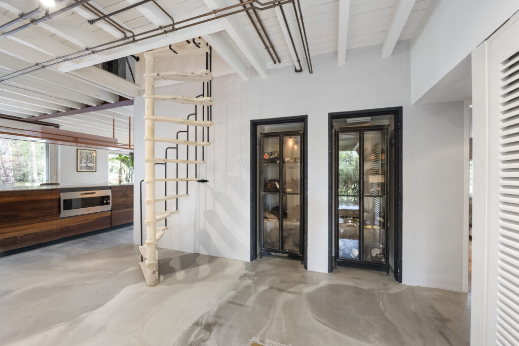 Modern kitchen with spiral staircase and glass doors