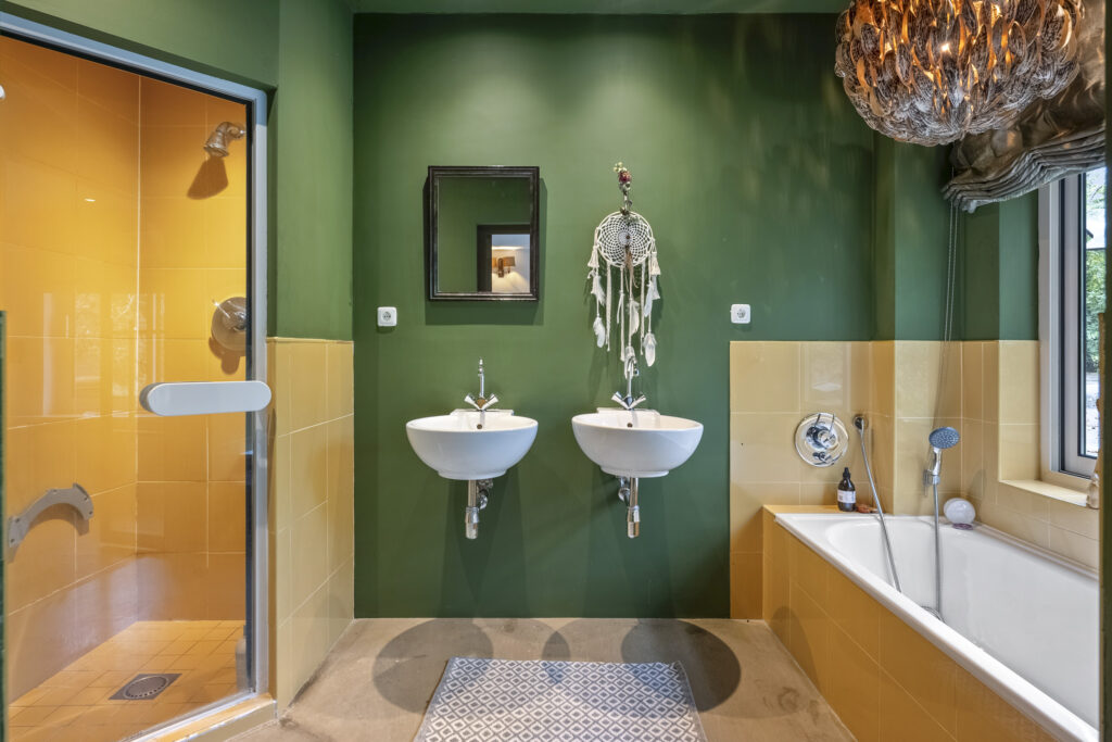 Colorful bathroom with dual sinks and shower.