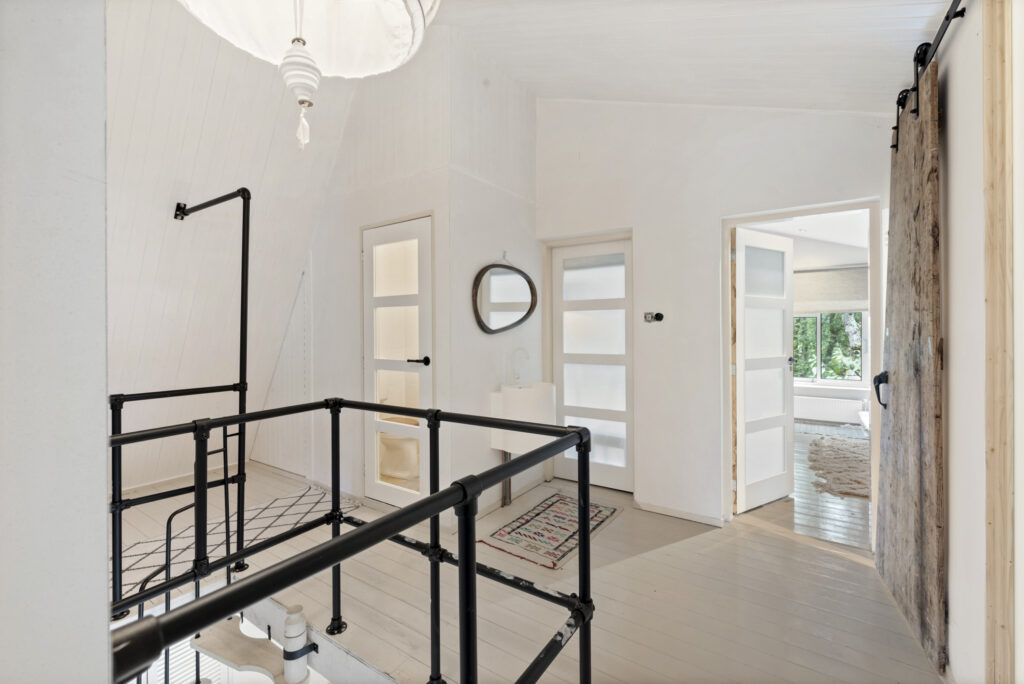 Modern hallway with wooden doors and railings