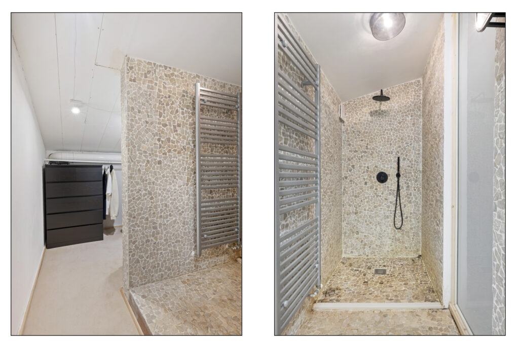 Modern shower and storage area with stone tiles.