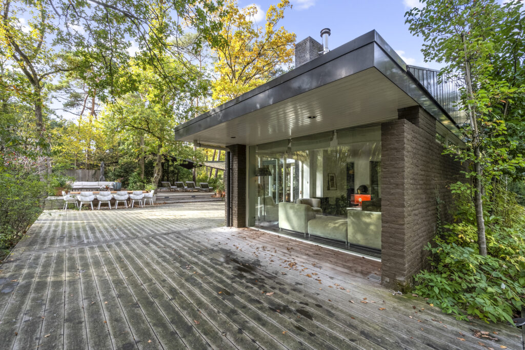 Modern house with outdoor patio and trees