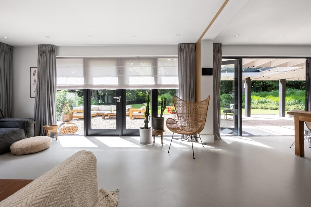 Bright living room with outdoor view, cozy seating area.